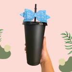Black plastic cup with a black lid, straw and blue bow