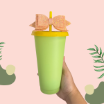 Green plastic cup example with a yellow lid, straw and bow