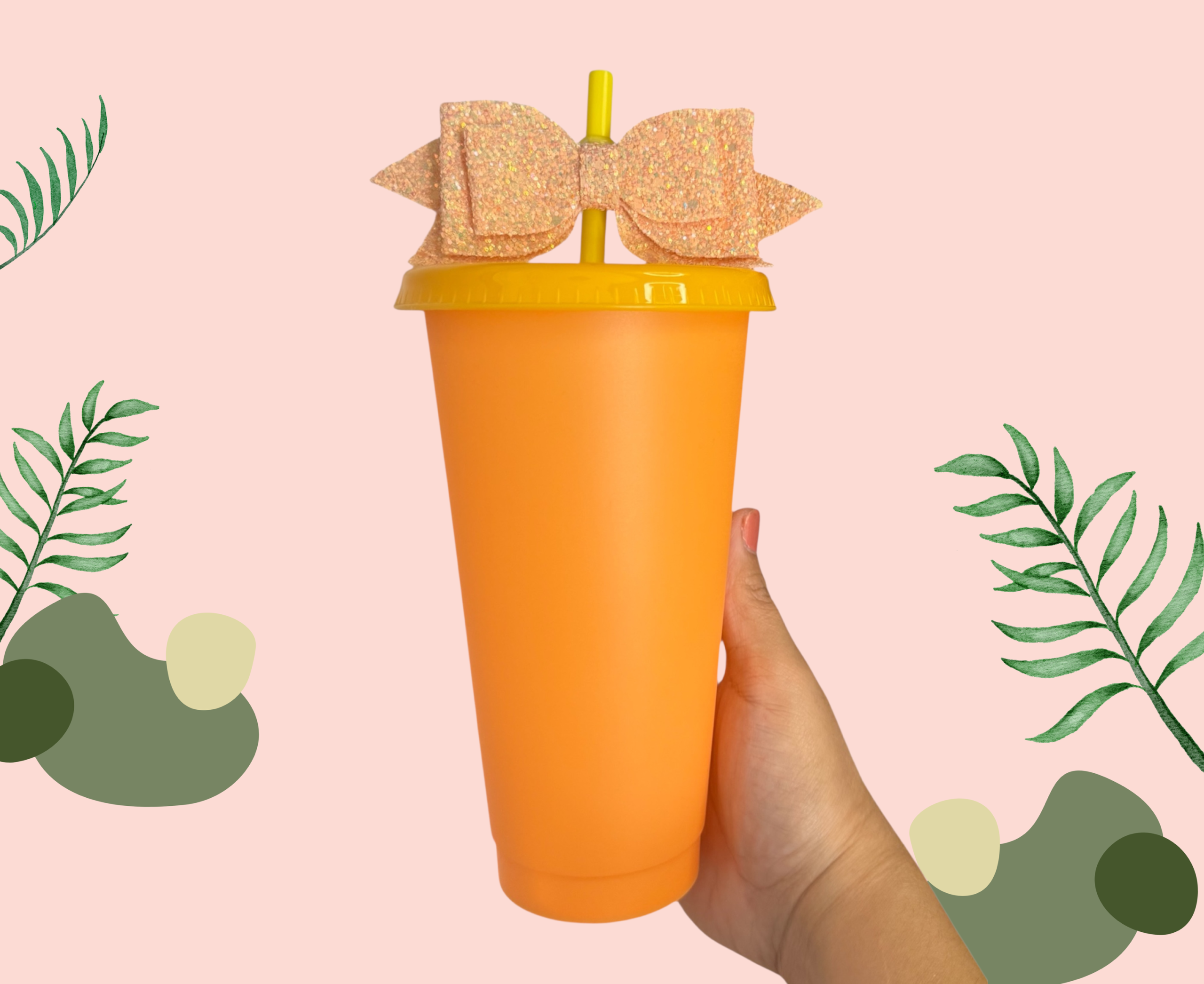 Orange plastic cup with a yellow lid, straw and bow