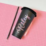 Black plastic cup with a personalized name, lid and straw