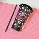 Black plastic cup with a personalized teacher design and straw